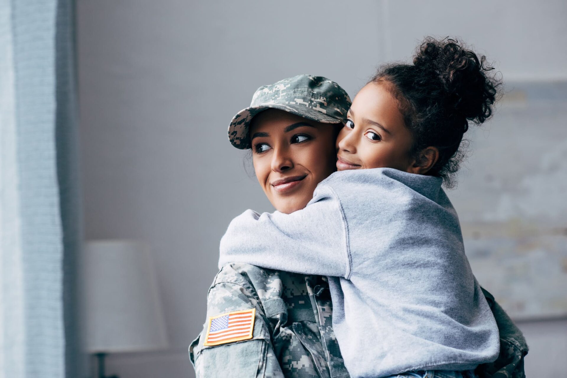 Military mother hugging her daughter