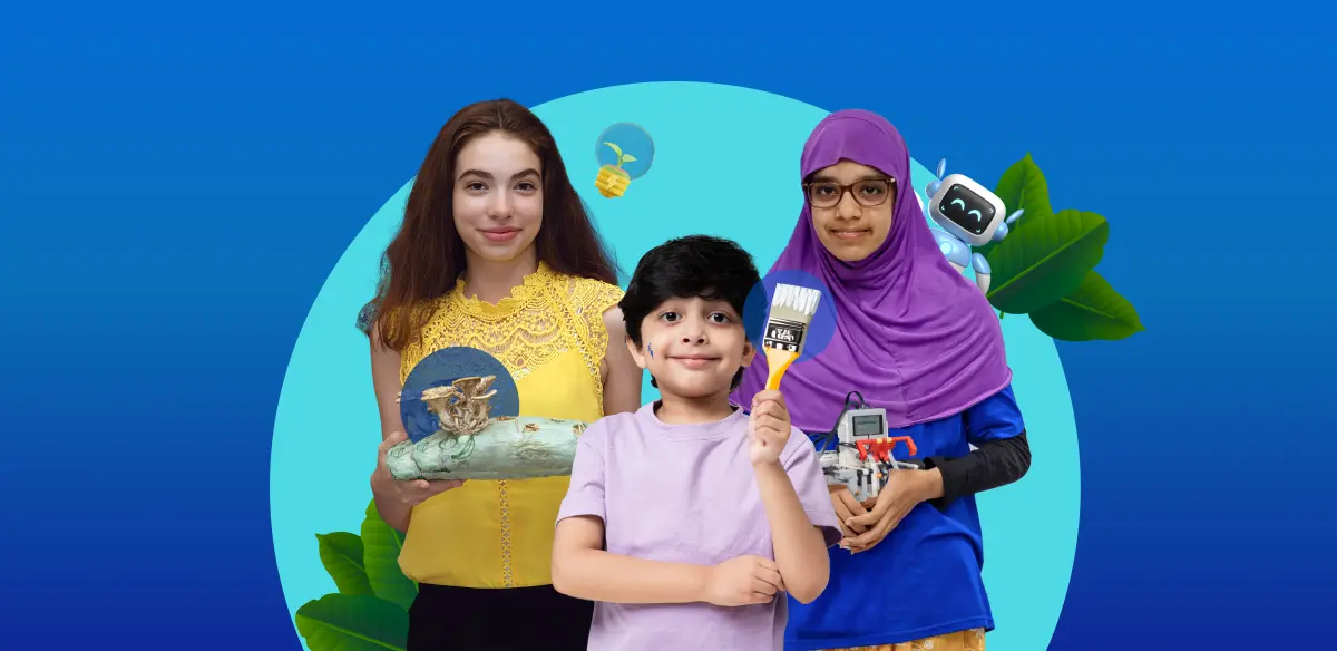 A girl holding an art project, a boy holding a brush and a girl holding a small robot