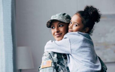 Military mother hugging her daughter