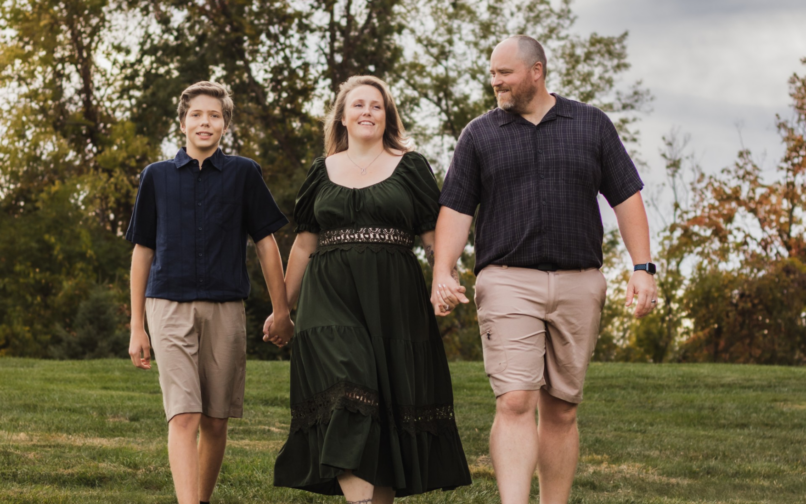 A Kentucky Virtual Academy military‑connected family walks together through a grassy park during the Month of the Military Child.
